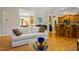 Well-lit living room with seamless view of the kitchen featuring hardwood floors and access to dining area at 200 Daniel Ridge Ln, Roxboro, NC 27574
