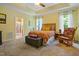 Spacious main bedroom with tray ceiling, a king bed, and ensuite bathroom with glass shower at 200 Daniel Ridge Ln, Roxboro, NC 27574
