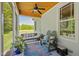 Inviting screened-in porch with comfortable seating and a view of the lush greenery at 200 Daniel Ridge Ln, Roxboro, NC 27574