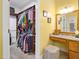 Well-organized walk-in closet featuring custom shelving, hanging rods, and a granite-topped vanity with an illuminated mirror at 200 Daniel Ridge Ln, Roxboro, NC 27574