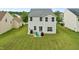 Backyard featuring well-maintained lawn, patio seating, and grill at 2004 Tennessee Rd, Durham, NC 27704