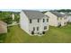 Backyard view of home, patio with chairs and grill, and expansive green space at 2004 Tennessee Rd, Durham, NC 27704