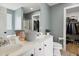 Bathroom featuring double vanity sink with mirror, and a walk-in closet with storage at 2004 Tennessee Rd, Durham, NC 27704