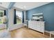 Bright bedroom with white dresser, blue accent wall, and large window at 2004 Tennessee Rd, Durham, NC 27704