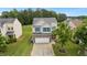 Beautiful home with stone accents, blue shutters, attached garage, and a well-maintained front yard at 2004 Tennessee Rd, Durham, NC 27704