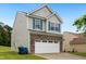 Two-story home featuring stone accents, vinyl siding, and blue shutters over a two car garage at 2004 Tennessee Rd, Durham, NC 27704