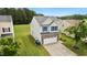 Charming two-story home featuring a stone facade, two-car garage, blue shutters, and a manicured lawn at 2004 Tennessee Rd, Durham, NC 27704