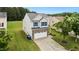 Aerial view of home with stone and vinyl siding, a driveway and mature landscaping at 2004 Tennessee Rd, Durham, NC 27704