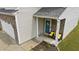 Inviting front entrance with a charming blue door and seating area with stone accents at 2004 Tennessee Rd, Durham, NC 27704