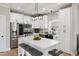 Stylish kitchen with stainless steel appliances, white cabinets, an island, and modern fixtures at 2004 Tennessee Rd, Durham, NC 27704