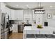 Modern kitchen featuring stainless steel appliances, an island with seating, and black hardware accents at 2004 Tennessee Rd, Durham, NC 27704