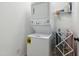 Efficient laundry room features stacked washer and dryer with adjacent shelving at 2004 Tennessee Rd, Durham, NC 27704