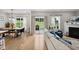 Bright living room featuring hardwood floors, fireplace, dining table, and access to the outdoor space at 2004 Tennessee Rd, Durham, NC 27704