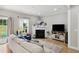 Bright and inviting living room with a fireplace, comfortable sofa, and views of the backyard at 2004 Tennessee Rd, Durham, NC 27704