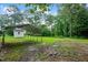 Large carport providing ample covered parking or storage space in a serene, green backyard at 202 Hamilton Rd, Bunnlevel, NC 28323