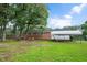 Spacious backyard featuring a brick home and carport, enhanced by a lush, green lawn at 202 Hamilton Rd, Bunnlevel, NC 28323