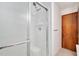 All-white shower with glass door features a shower head, seat, and shampoo shelf at 202 Hamilton Rd, Bunnlevel, NC 28323