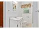 Bright bathroom with white vanity, mirror, and floral window valance at 202 Hamilton Rd, Bunnlevel, NC 28323