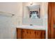 Traditional bathroom featuring a vanity with white countertop, stylish fixtures, and a decorative mirror at 202 Hamilton Rd, Bunnlevel, NC 28323