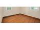 Cozy bedroom featuring hardwood floors and natural light from two windows at 202 Hamilton Rd, Bunnlevel, NC 28323