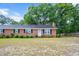 Charming single-story brick home featuring a cozy front yard and traditional curb appeal at 202 Hamilton Rd, Bunnlevel, NC 28323