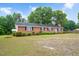 Charming single-story brick home with manicured bushes, located on a spacious and green lot at 202 Hamilton Rd, Bunnlevel, NC 28323