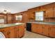 An open kitchen featuring wood paneling and a stainless steel sink under a window at 202 Hamilton Rd, Bunnlevel, NC 28323