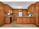 A kitchen with wood paneling, wood cabinets and a breakfast bar separating the food prep area at 202 Hamilton Rd, Bunnlevel, NC 28323