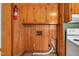 A laundry area with wood paneling, wood cabinets, and connections for a washing machine at 202 Hamilton Rd, Bunnlevel, NC 28323