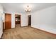 A carpeted living room featuring an ornate light fixture and an open doorway to the kitchen at 202 Hamilton Rd, Bunnlevel, NC 28323
