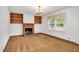 Inviting living room with a classic brick fireplace, built-in shelves, and a bright window at 202 Hamilton Rd, Bunnlevel, NC 28323