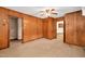 A room with wood paneling and open doorways into other rooms of the house at 202 Hamilton Rd, Bunnlevel, NC 28323
