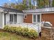 Back deck area with outdoor grill, stylish white railing, and decorative landscaping at 203 W Boundary St, Cary, NC 27513