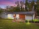 Private backyard features a stone patio, a built-in grill and an inviting fire pit perfect for entertaining at 203 W Boundary St, Cary, NC 27513