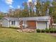 Spacious backyard featuring a brick patio, outdoor grill, and a stone fire pit with seating at 203 W Boundary St, Cary, NC 27513