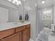 Bathroom featuring a single sink vanity, mirror, and shower with curtain, all with neutral paint at 203 W Boundary St, Cary, NC 27513