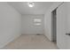 A simple bedroom featuring a window, carpet, and a closet at 203 W Boundary St, Cary, NC 27513