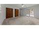 Bedroom with multiple closets, ceiling fan, and sliding glass door to outdoor patio at 203 W Boundary St, Cary, NC 27513