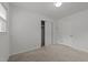 A simple carpeted bedroom featuring a closet and a window at 203 W Boundary St, Cary, NC 27513