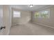 Neutral bedroom featuring carpeted floors, two windows, and a closet with painted trim at 203 W Boundary St, Cary, NC 27513