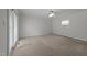 Neutral carpeted bedroom featuring a ceiling fan, one window, and sliding glass door at 203 W Boundary St, Cary, NC 27513
