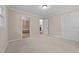 Bedroom with carpeted floor and trim featuring view into bathroom and extra room at 203 W Boundary St, Cary, NC 27513