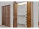 Open closet with exposed shelved and louvered wood door at 203 W Boundary St, Cary, NC 27513