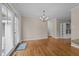 Open dining room with hardwood floors, a modern chandelier, and French doors at 203 W Boundary St, Cary, NC 27513