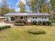 Well-maintained home featuring a metal roof, brick accents, and professional landscaping at 203 W Boundary St, Cary, NC 27513