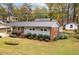 Well-kept home with a metal roof, brick accents, and landscaped front yard at 203 W Boundary St, Cary, NC 27513