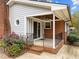 Charming front porch with brick accents, iron railings, and a cozy covered entryway at 203 W Boundary St, Cary, NC 27513