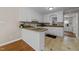 Well-appointed kitchen with white cabinets, granite countertops, and tiled floors at 203 W Boundary St, Cary, NC 27513