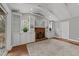 Cozy living room with a brick fireplace, built-in shelving, and hardwood floors at 203 W Boundary St, Cary, NC 27513