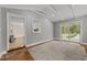 Bright living area featuring hardwood floors, vaulted ceilings, and sliding glass doors to the outdoors at 203 W Boundary St, Cary, NC 27513
